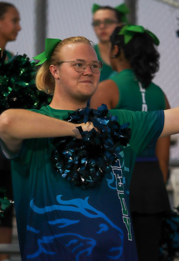 Senior Autumn Graham cheers with the Color Guard. The Color Guard watched the football game and did specific cheers according to songs played by the band.